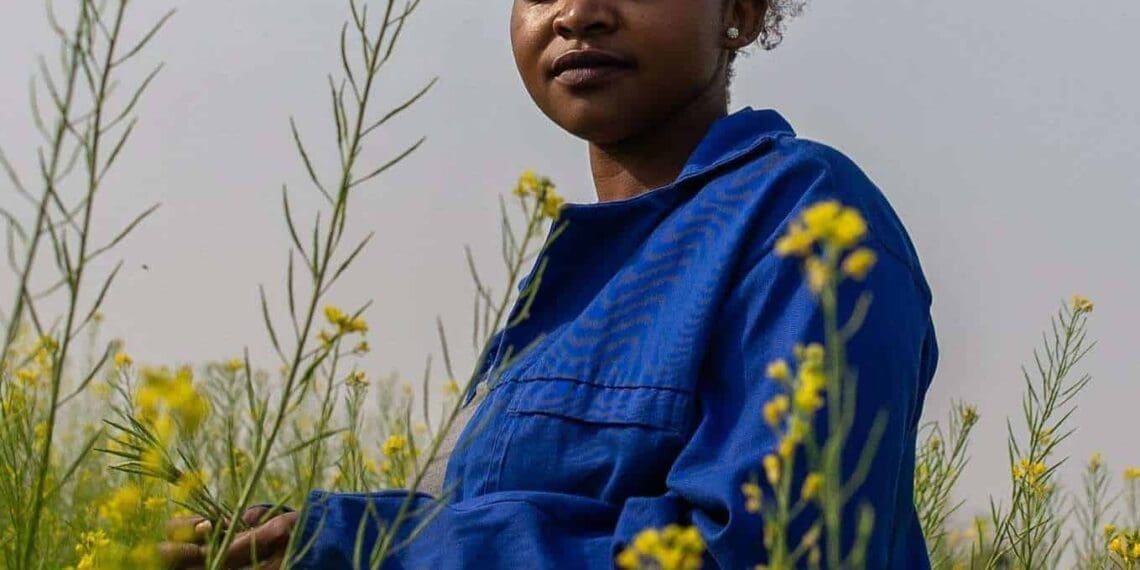 6 September 2018: 27-year-old Dineo Boshomane standing in a field of some of the Chinese spinach which she grows on her one-hectare farm in Northern Farm, Diepsloot. | Photo: Ihsaan Haffejee, New Frame.