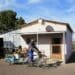 Max Ndamane, with the bicycle-drawn trailer he made for his gardening services in Richmond, in front of the old ramstal he turned into a home. Photo: Chris Marais