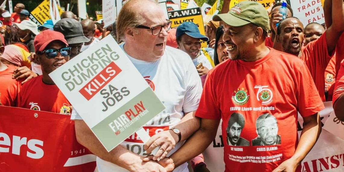 Francois Baird and Katishi Masemola of the Food and Allied Workers Union march for jobs.