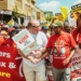 Francois Baird and Katishi Masemola of the Food and Allied Workers Union march for jobs.