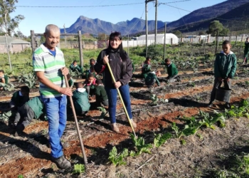 Johan Hus Primary school caretaker Georgie Botha (left) and principal Desiree Mey (right), with the school learners tending to the garden.