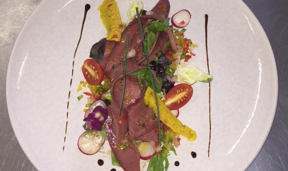 Chef Sibu Nyembe's braised ox tongue salad on a bed of summer salad.