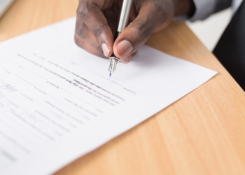 Man signing a contract. Unsplash picture