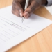 Man signing a contract. Unsplash picture