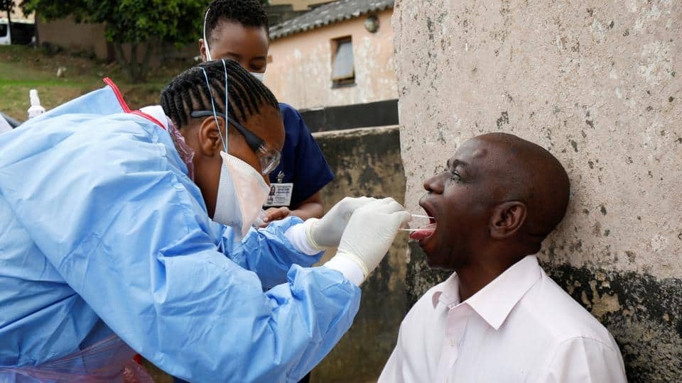 A health worker wearing a protective suit takes a swab from a resident during earlier door-to-door testing in an attempt to contain the coronavirus disease outbreak, in Umlazi township near Durban. Photo: AFP