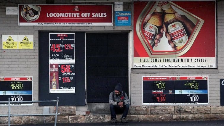A bystander sits outside a closed liquor store during a nationwide lockdown due to the outbreak of the coronavirus disease. Photo: Reuters