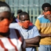 Community members wearing protective face masks as they queue for aid in Zandspruit informal settlement, north of Johannesburg. Phill Magakoe/AFP via Getty Images
