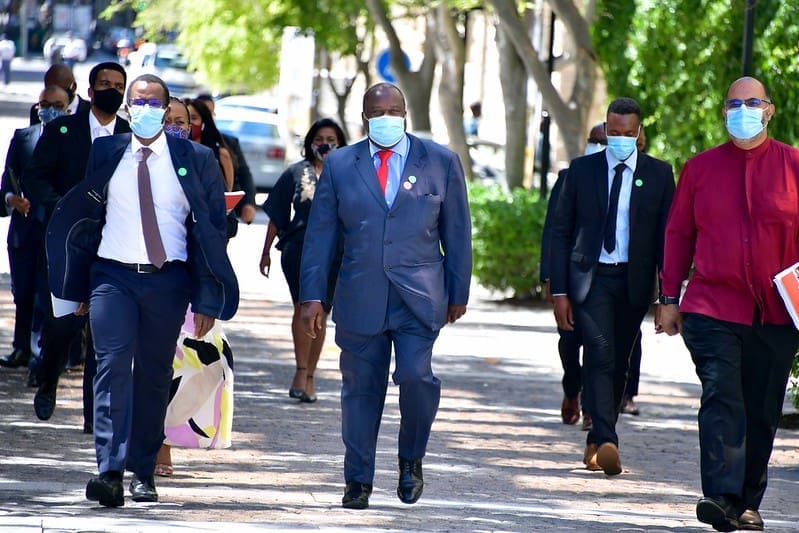 Finance minister Tito Mboweni and National Treasury officials makes their way to Parliament ahead of the 2021 budget speech. Photo: GCIS/Flickr