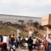 Suspected looters carry goods from the Game Warehouse in Durban on 13 July 2021. President Cyril Ramaphosa deployed troops in a bid to quell unrest that has claimed at least 50 lives. Photo: AFP