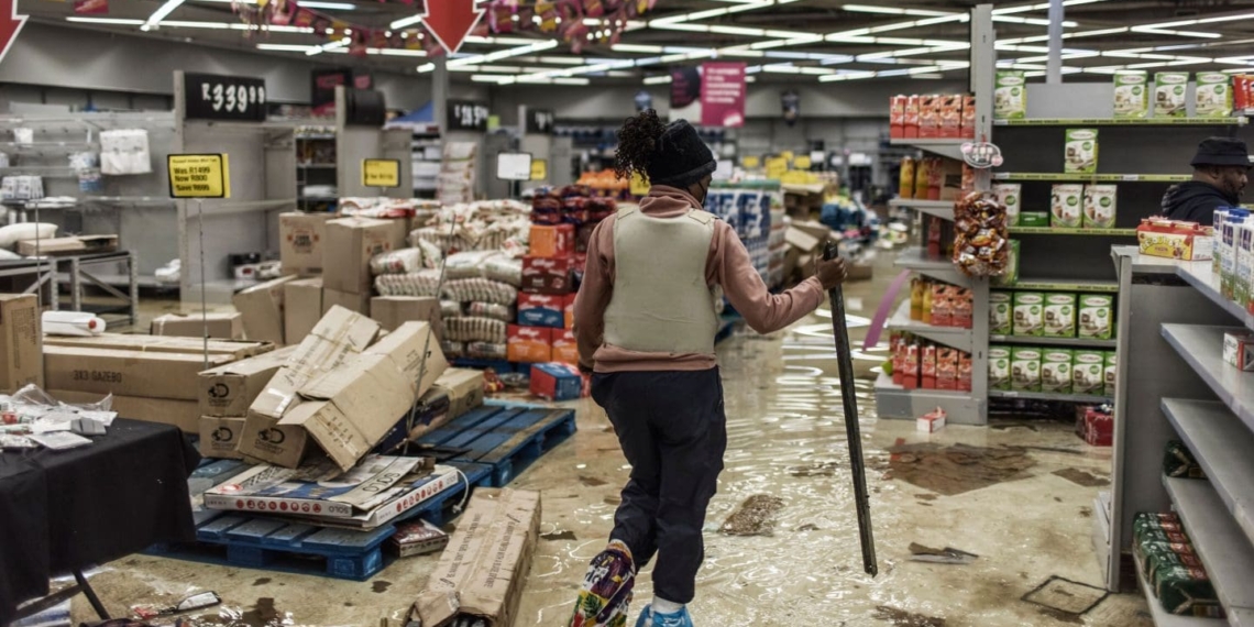 A police officer inspects the damage at one of the recently looted malls in Gauteng. Photo: Getty Images