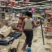 A police officer inspects the damage at one of the recently looted malls in Gauteng. Photo: Getty Images