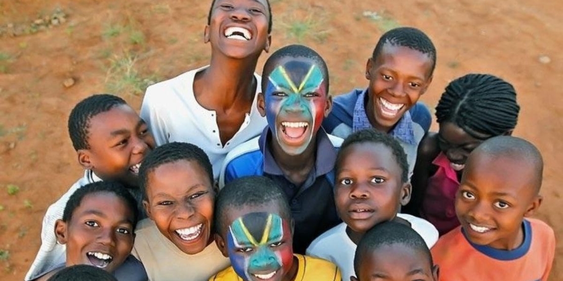 Mandela Day: An earlier picture of the brothers Thabana and Tsholofelo Matlhonoko with their faces painted in the South African flag, posing with their friends. Photo: Marc Aspland/The Times