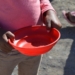 A South African child waits for a bowl of food during hard lockdown in April 2020. Photo: Elana van der Watt/Food For Mzansi