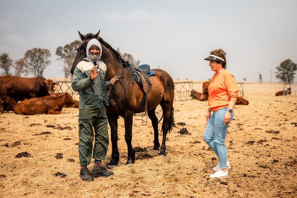 Stinie and one of her employees tending to a horse. Photo: Jean Rossouw/Food For Mzansi