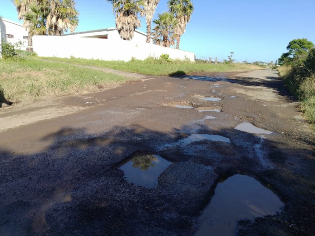 Potholes right outside the house of Eastern Cape dairy farmer Siviwe Tikane. Photo: Supplied/Food For Mzansi