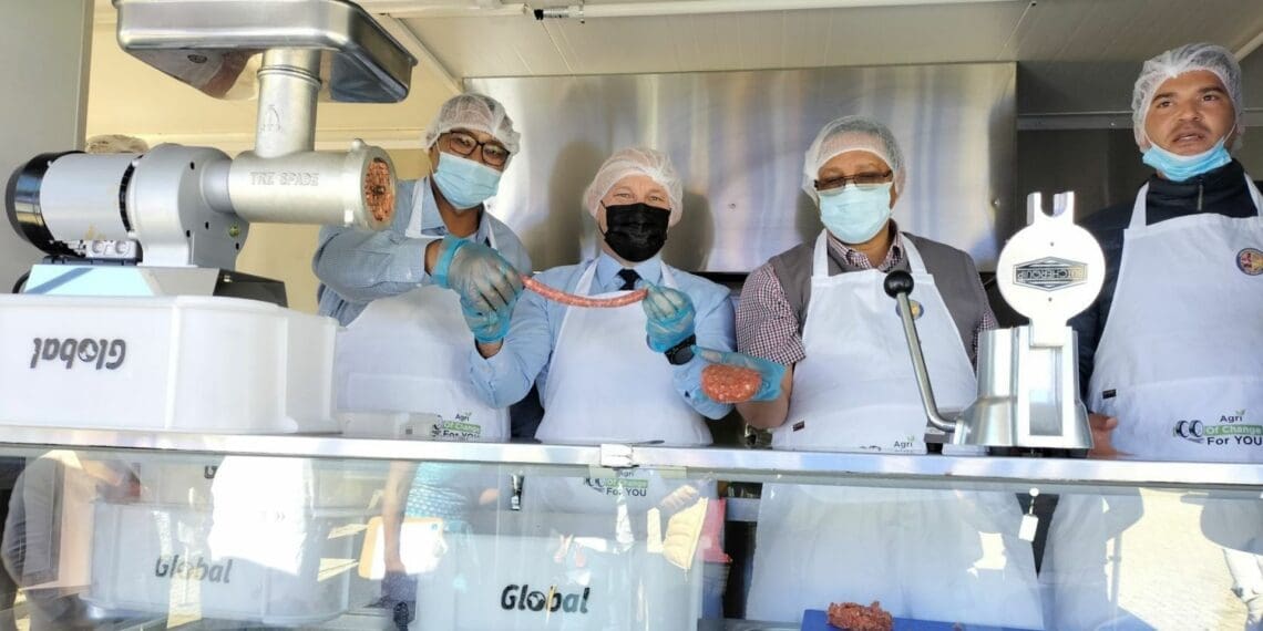 Dr Harry Malila, Head of Department and Accounting Officer for the Department of the Premier, Mayor Alderman Franken and minister of agriculture Ivan Meyer showing off freshly made sausage and patti. Photo: Supplied/Food For Mzansi