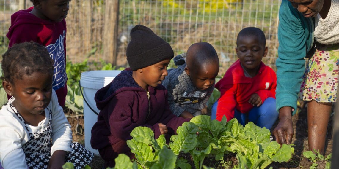 Some of the children with the ECD practitioner Yolanda Shabalala. Zero2Five Trust promotes holistic Early Childhood Development in formerly disadvantaged areas by improving learners’ health and education outcomes with nutrition and education programmes. Photo: Supplied/Zero2Five Trust