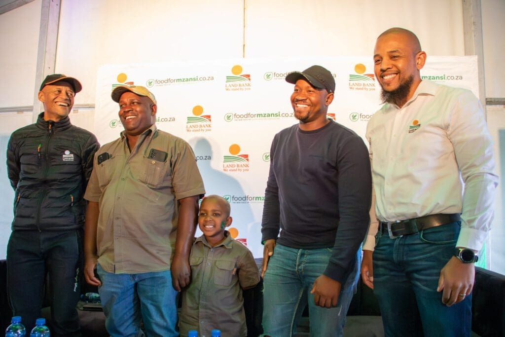 Sydney Soundy, executive manager for strategy and communications at Land Bank, flanked by, among others, Free State farmer Frans Mokoena, and Cassim Abdullah, executive manager for sales and distribution at Land Bank Insurance Company. Photo: Gareth Davies/Food For Mzansi