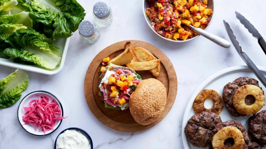 Savouring the flavours of South Africa! Whipped feta, mango peppadew relish, and perfectly seasoned lamb patties – a symphony of tastes in every bite this #FridayBraaiDay. Photo: Michelle Parkin/RMITED
