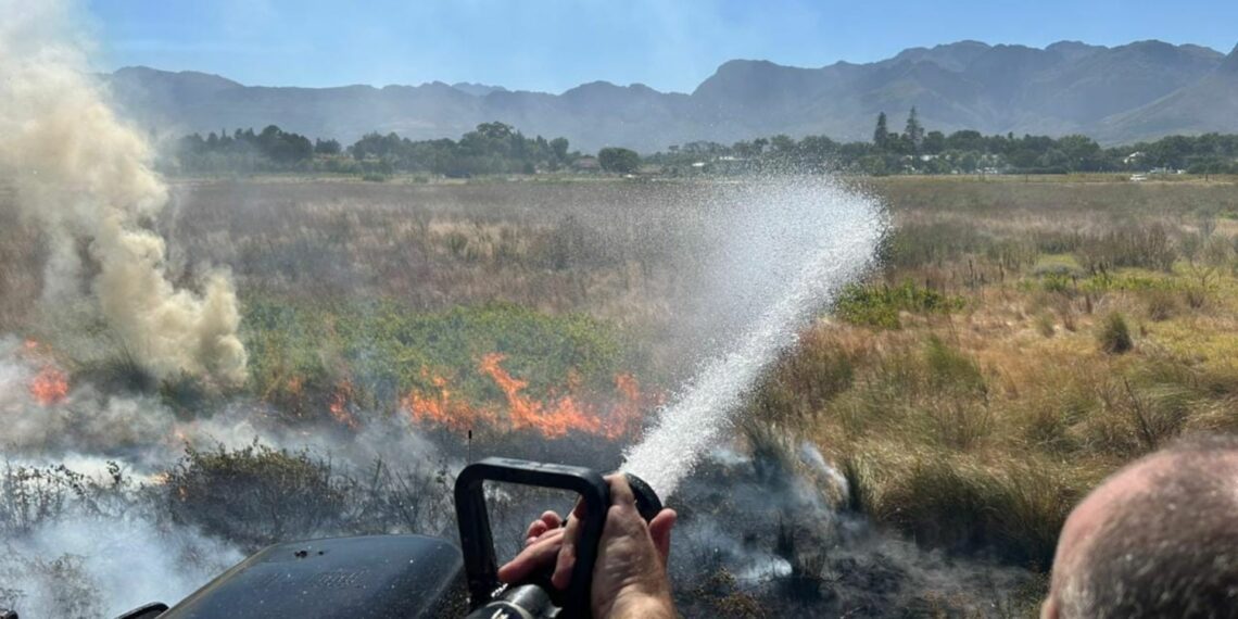 Farming communities in the Western Cape can heave a sigh of relief after veld fires have been extinguished but they are cautioned not to relax. Photo: Supplied/DFW