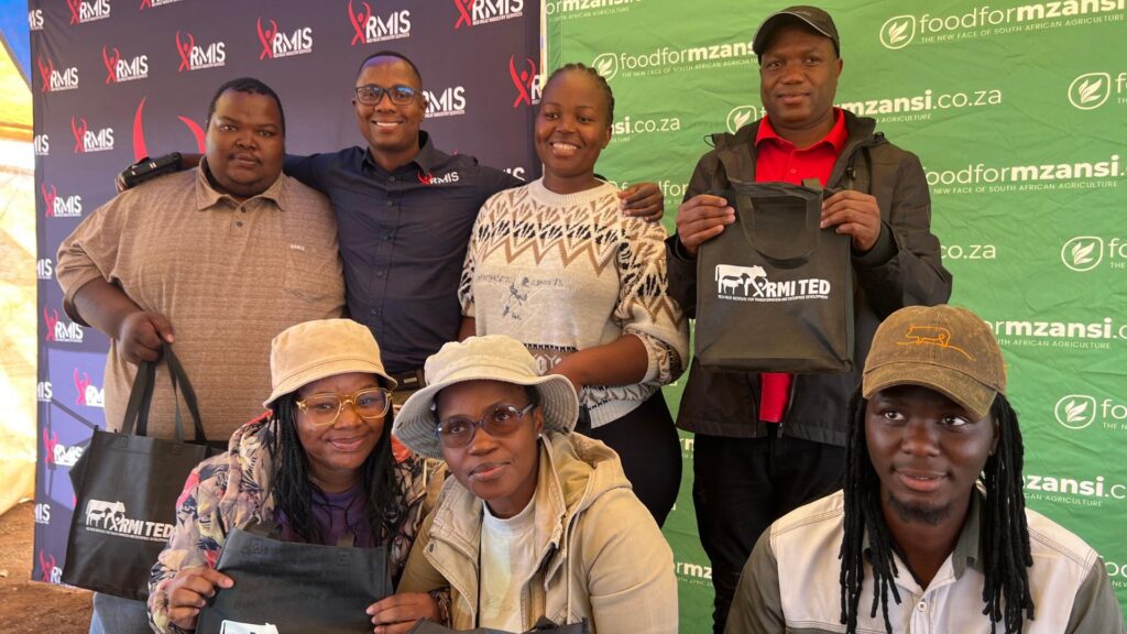 Ernest Makua from RMIS with farmers proudly displaying their gift packs, including weighing belts and veterinary-grade thermometers, after an insightful session on cattle breeding management. Photo: Ivor Price/Food For Mzansi