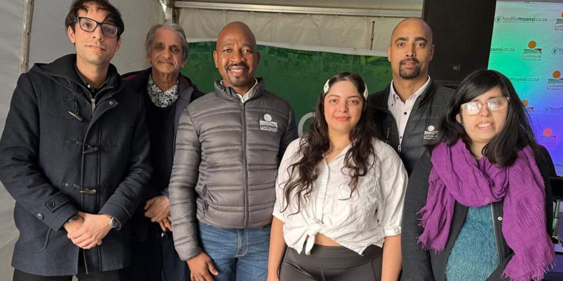 Land Bank CEO Themba Rikhotso with Kauthar (29) and Zaid Noor (35), along with their family, in Montagu, Western Cape. Kauthar and Zaid, Land Bank clients, successfully acquired their 84.34 ha peach farm with support from the blended finance scheme. The family expressed their gratitude to Land Bank for the assistance. Photo: Ivor Price/Food For Mzansi