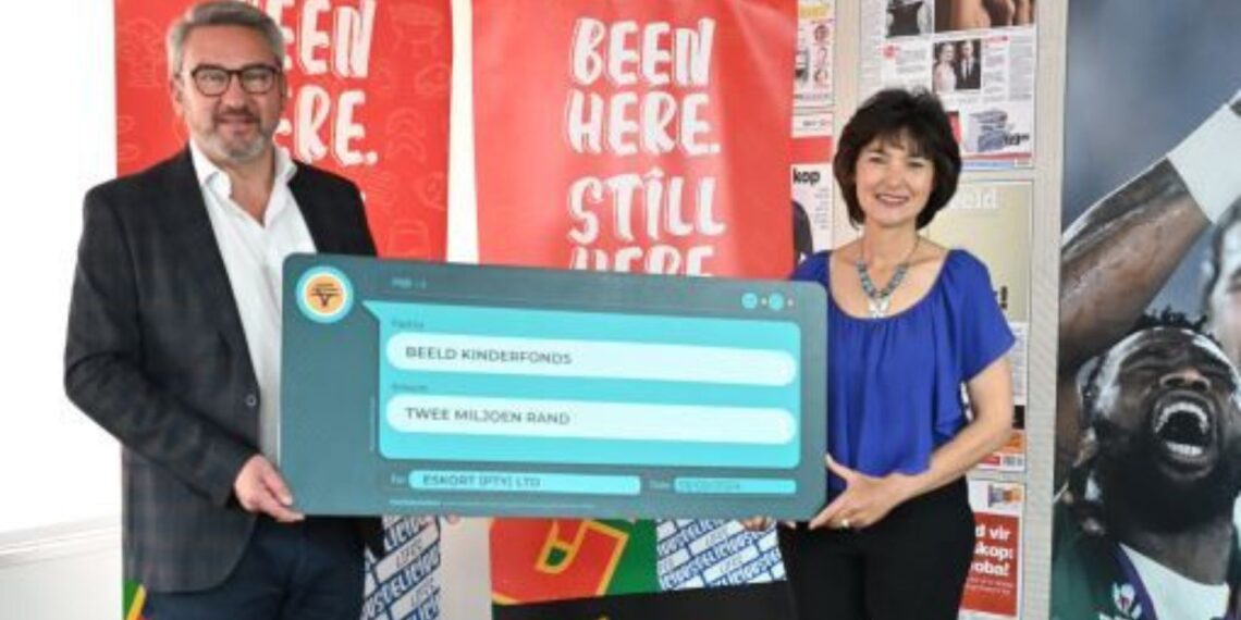 Eskort chief executive Arnold Prinsloo and Adrie van Staden, chief executive of Beeld-Kinderfonds, celebrate the successful handover of R2 million raised through the Liberi wine initiative. Photo: Supplied/Food For Mzansi