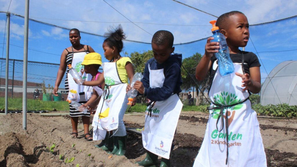 Young participants in Afrika Tikkun’s Garden-to-Kindergarten programme proudly display their freshly harvested vegetables, showcasing the fruits of their labour while learning valuable lessons about healthy eating and the benefits of growing their own food. Photo: Supplied/Food For Mzansi