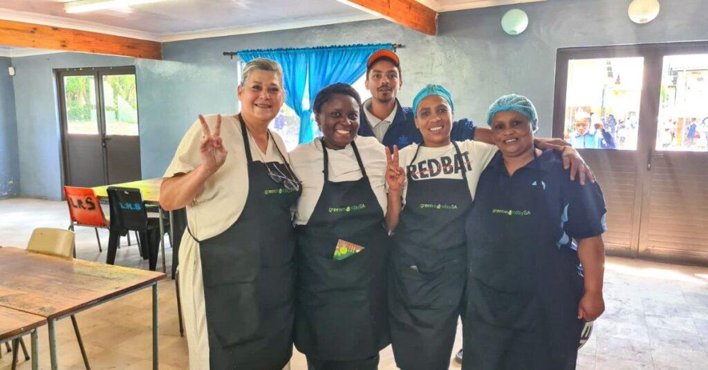 Norah Hudson from HSI/Africa, chef Jane Nshuti, and school cooks Danell Sauls, Elisma Mageman, and Daylin Loffand (at the back) collaborate to create nutritious, plant-based meals for students in the Genadendal Valley. Photo: Supplied/Food For Mzansi
