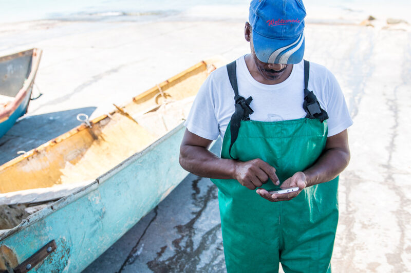A fisherman uses the ABALOBI app, empowering local communities through sustainable fishing practices and connecting them to global markets. Photo: Supplied/Food For Mzansi