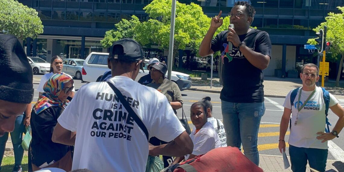 Activists gather outside the CTICC, holding their memorandum demanding urgent government action to end hunger and reform South Africa’s food system. Photo: Lisakanya Venna/Food For Mzansi