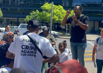 Activists gather outside the CTICC, holding their memorandum demanding urgent government action to end hunger and reform South Africa’s food system. Photo: Lisakanya Venna/Food For Mzansi