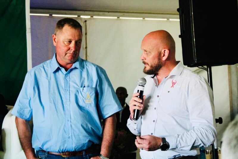 Grant Naudé, president of Merino SA, and Dewald Olivier, CEO of Red Meat Industry Services, speaking at a Nampo Cape engagement with Deputy President Paul Mashatile. Photo: Supplied/Land Bank