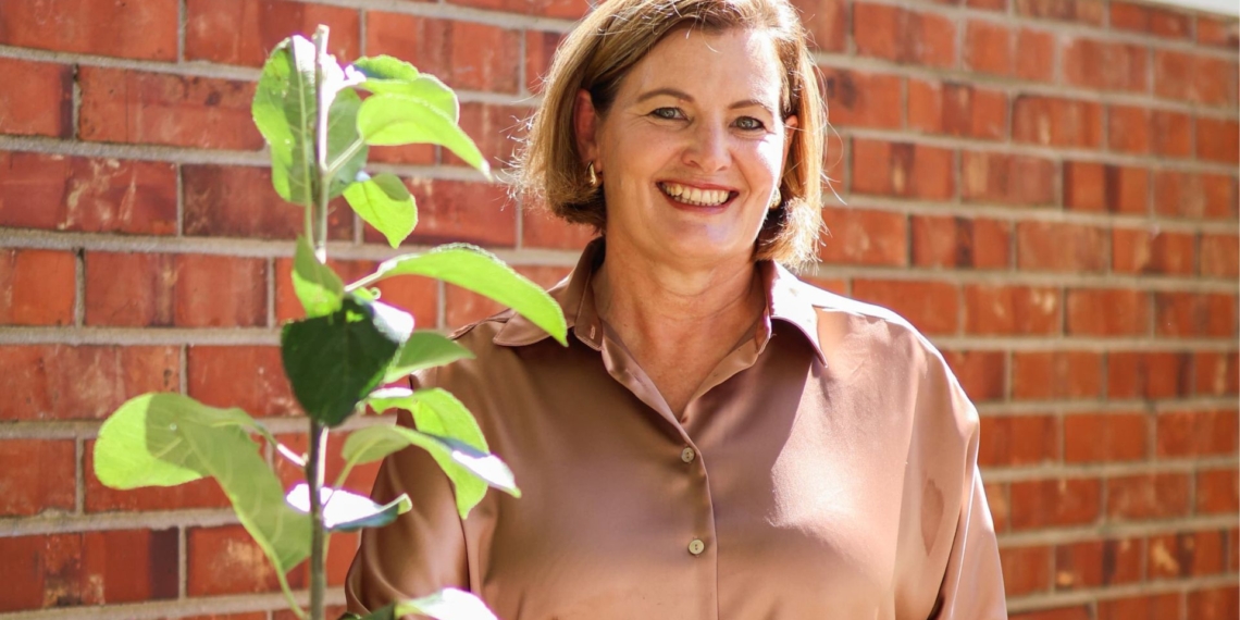 Jeanne Fourie, Tru-Cape’s new variety specialist, with the young Witte Wijnappel she planted in the garden of Jan van Riebeeck High School in Cape Town as part of the school’s centenary celebrations. Photo: Tru-Cape