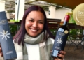 Anesca Achilles, marketing co-ordinator of Visio Vintners, with the Decanter awarded wine. Photo: Supplied/Food For Mzansi