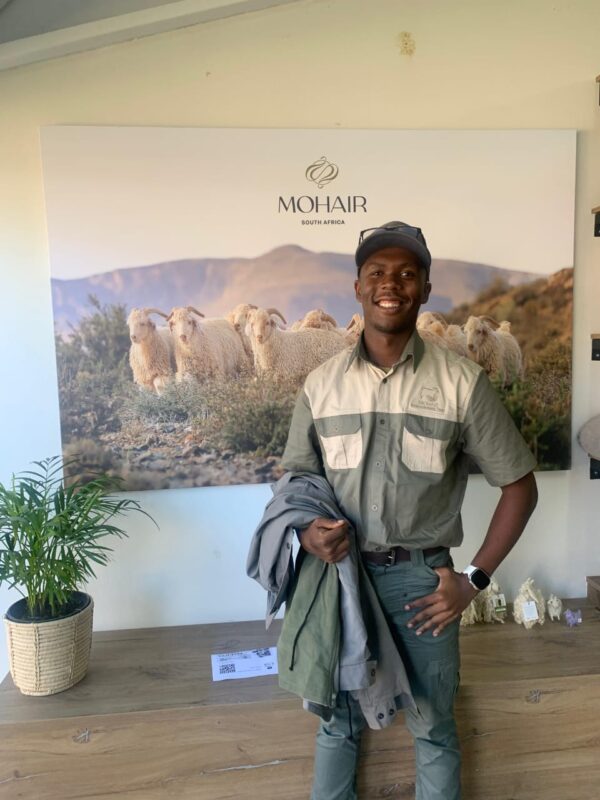 Uzusakhe Mbebe is combining his academic studies with hands-on experience from the Mohair Empowerment Trust to scale up his family’s wool and mohair business on communal land in Mceula village. Photo: Supplied/Food For Mzansi
