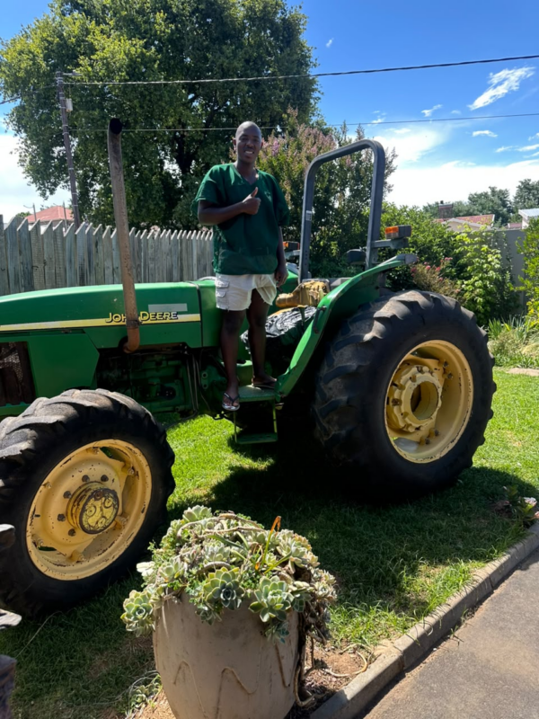 Eastern Cape farmer Aphola Mbotshwa, who pooled family savings to buy a tractor and now hires it out to neighboring producers to offset costs. Photo: Supplied/Food For Mzansi