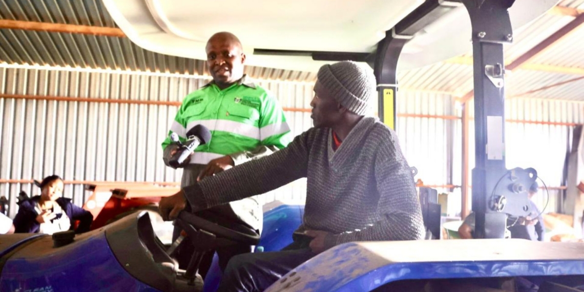 North West agriculture MEC Madoda Sambatha with local farmer and beneficiary, Ramasimane Kalaote. The shared-service tractor is set to support farmers across Tigane by improving access to mechanised farming services. Photo: Supplied/Food For Mzansi